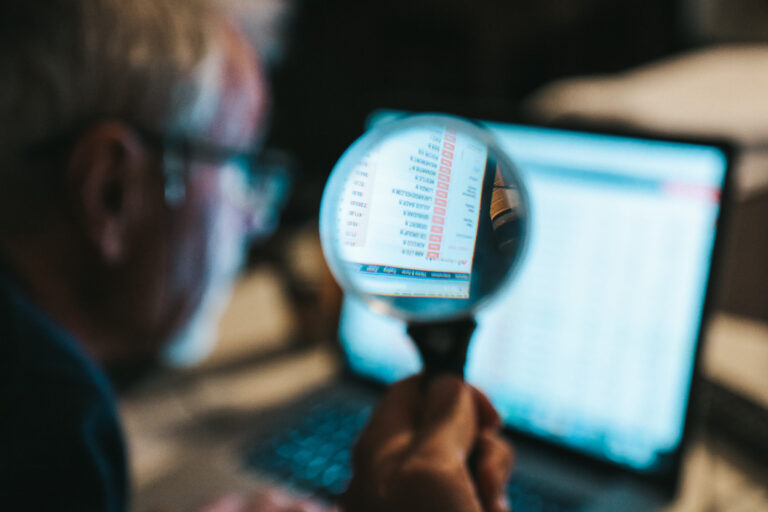 Old man with magnifying glass