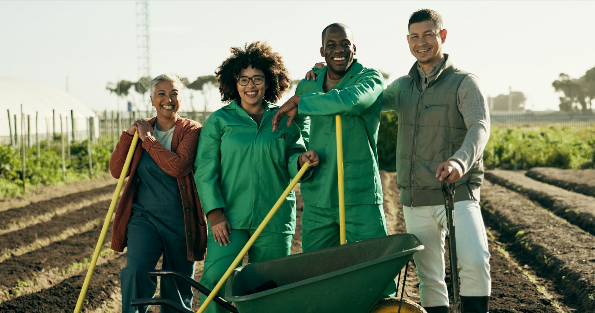 Portrait, people or team for agriculture on farm with tools, wheelbarrow or equipment for planting.