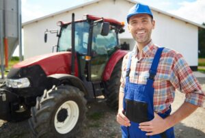 Man in unform and farm in the background